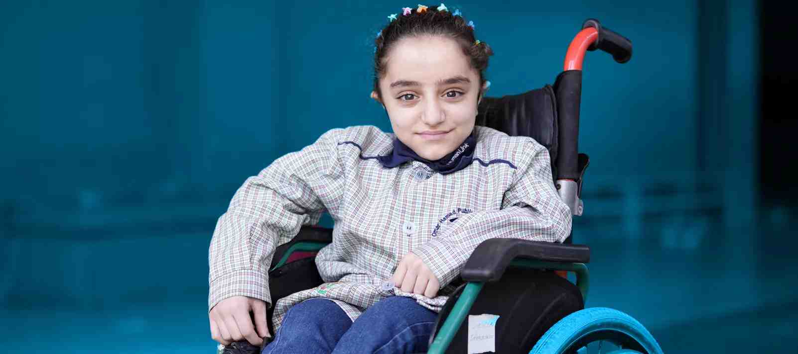 Smiling girl in a wheelchair, UNICEF Lebanon website.