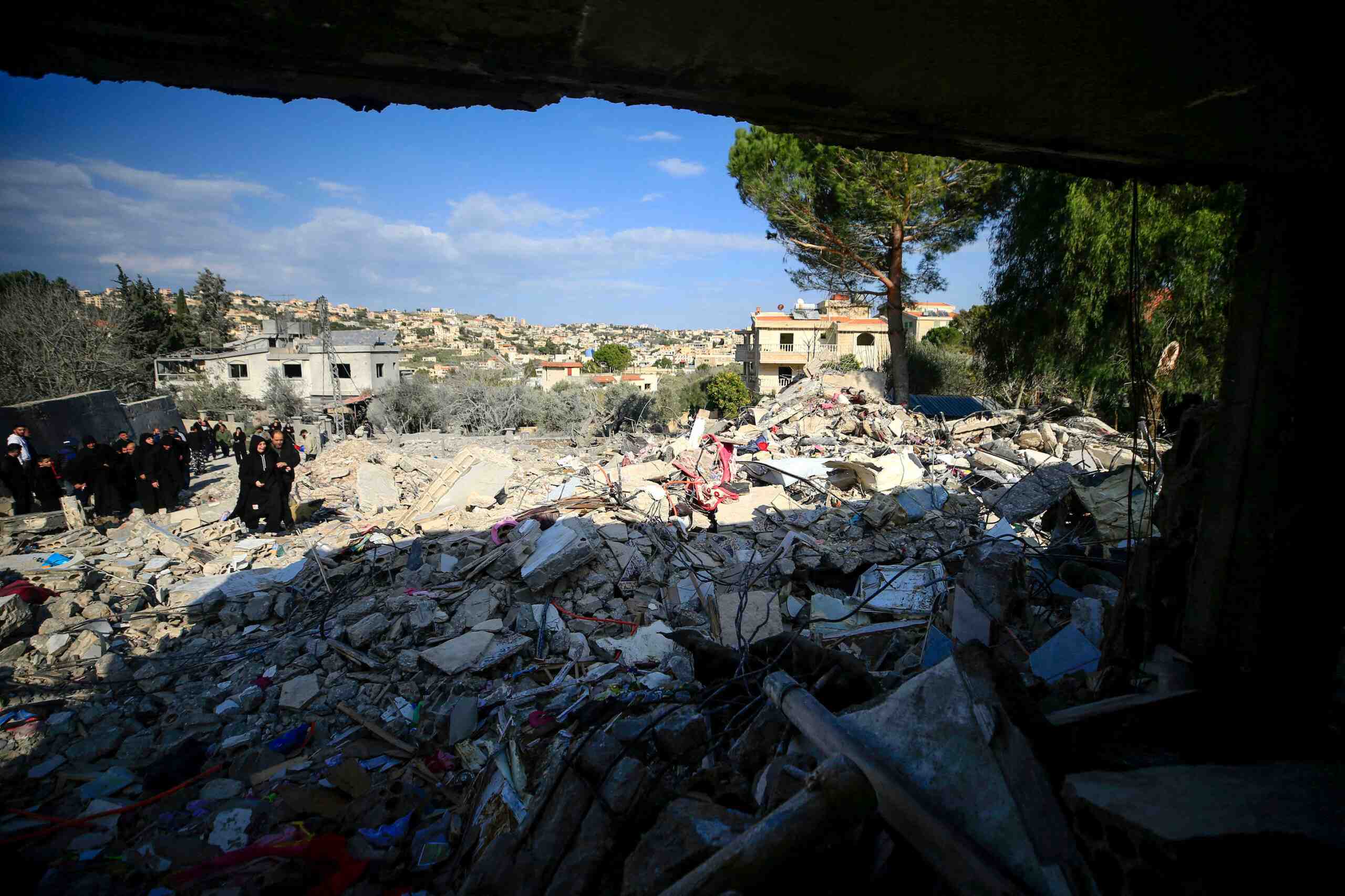 People check the rubble of a building in Bint Jbeil in southern Lebanon, on December 27, 2023. (Photo by AFP)