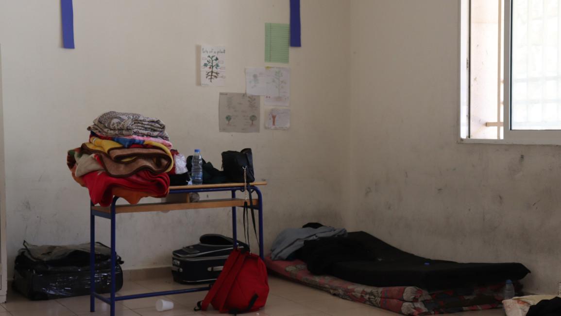 Desks are being used as storage decks as people try to make homes inside the foreign white walls Desks are being used as storage decks as people try to make homes inside the foreign white walls