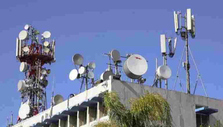 A rooftop crowded with various telecommunication antennas