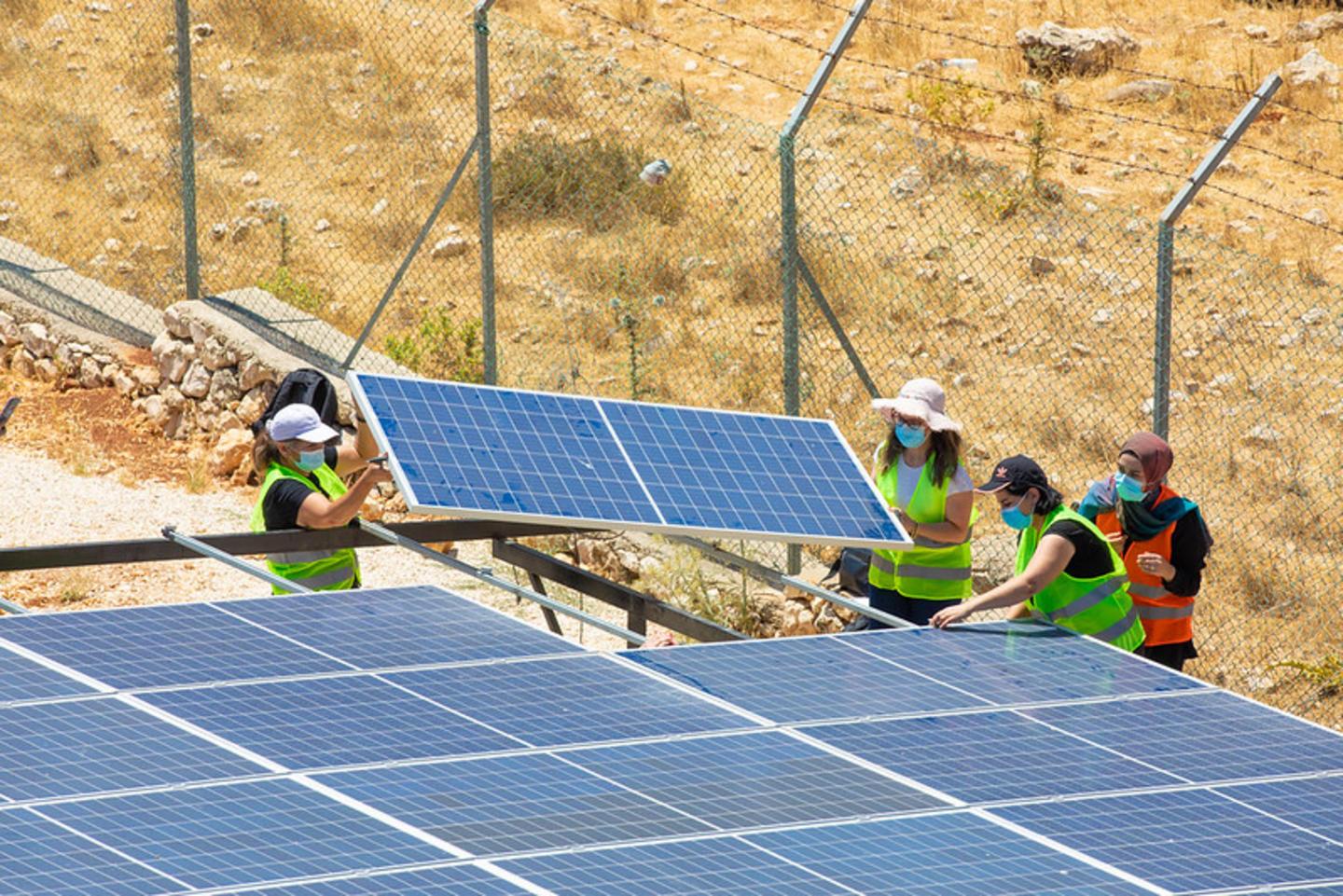 Workers installing solar pannels. Workers installing solar pannels.