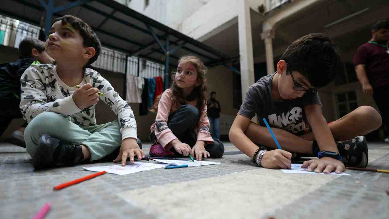 Children from towns in southern Lebanon sit in a shelter in the capital, Beirut. © AFP